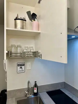 a kitchen with a sink and a counter top at L and D Homestay in Manila