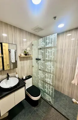 a bathroom with a sink and a toilet and a shower at L and D Homestay in Manila