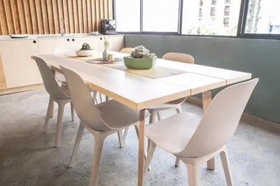 a white table and chairs in a room at HomeBase Apartment Hotel in Manila