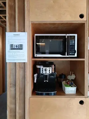 a kitchen with a microwave and a coffee maker at HomeBase Apartment Hotel in Manila