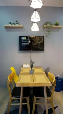 a dining room table with yellow chairs and a yellow table at THE FIKA ROOM near MNL Airport - Scandi Studio Unit with Fast Wi-Fi & Netflix - Read Full Property Desc before booking in Manila