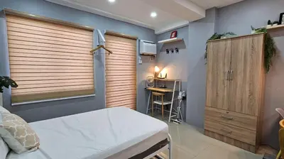 a bedroom with a bed and a desk in a room at THE FIKA ROOM near MNL Airport - Scandi Studio Unit with Fast Wi-Fi & Netflix - Read Full Property Desc before booking in Manila