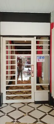 a person walking through the front door of a store at KS RESIDENCES in Manila