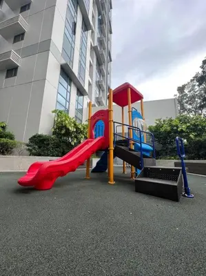 a playground with a slide in front of a building at Chic and Cozy Studio Viceroy Residences Taguig in Manila