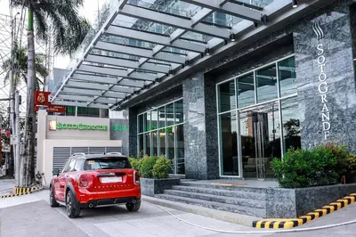 a red car parked in front of a building at Sotogrande Hotel Katipunan in Manila