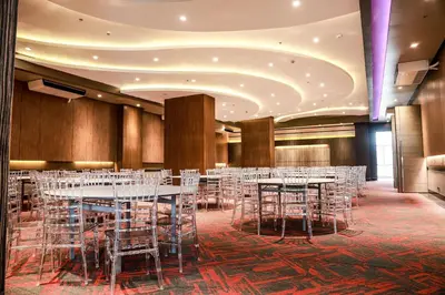 a banquet hall with white tables and chairs at Sotogrande Hotel Katipunan in Manila