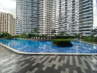 a large swimming pool in front of a large building at Air Residences 1-Bedroom condo in Makati in Manila