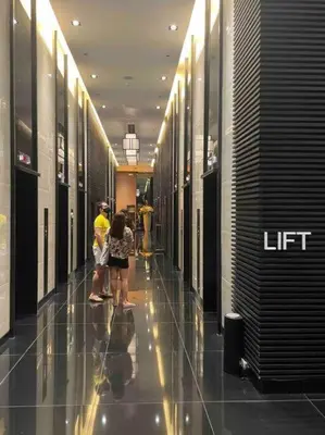 a group of people walking down a hallway in a building at Air Residences 1-Bedroom condo in Makati in Manila