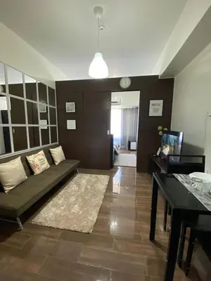 a living room with a couch and a table at Air Residences 1-Bedroom condo in Makati in Manila