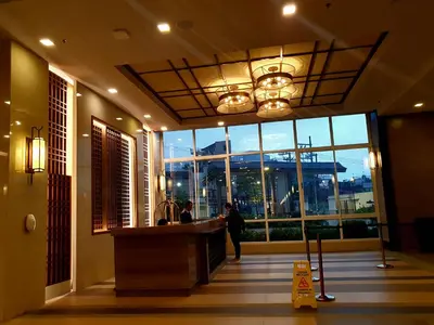 a lobby of a hotel with a person standing at a counter at mandaluyong 2 br condo for rent in Manila