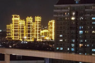 a city lit up at night with tall buildings at mandaluyong 2 br condo for rent in Manila