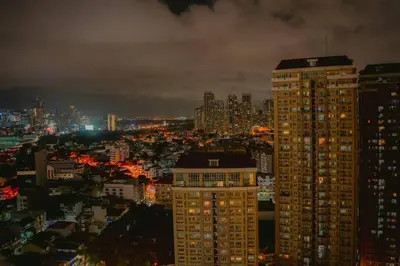 a city skyline at night with tall buildings at mandaluyong 2 br condo for rent in Manila
