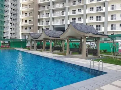 a swimming pool with a gazebo next to a building at mandaluyong 2 br condo for rent in Manila