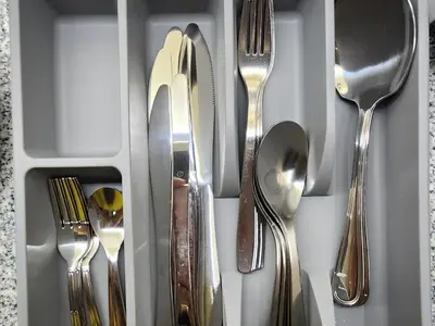 a drawer full of silver utensils in a drawer at Casa Antonio At Uptown Parksuites Two in Manila