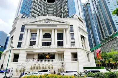 a white building with cars parked in front of it at Casa Antonio At Uptown Parksuites Two in Manila