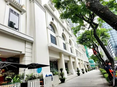 a building with a person sitting in front of it at Casa Antonio At Uptown Parksuites Two in Manila