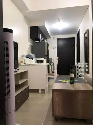a kitchen with a table and a counter in a room at Kasara Urban Resort and Residences in Manila