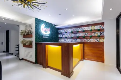 a lobby of a fast food restaurant with a sign on the wall at Nest Nano Suites Poblacion - Makati in Manila