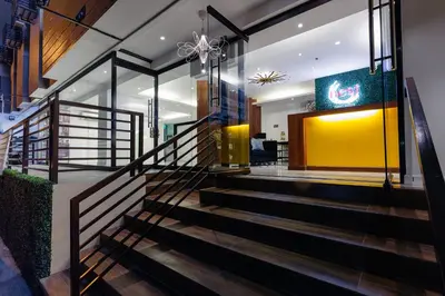 a staircase in a house with a yellow wall at Nest Nano Suites Poblacion - Makati in Manila