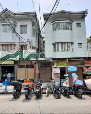 a group of motorcycles parked in front of a building at Budget Transient Capsule Room Makati near Ayala and Buendia in Manila