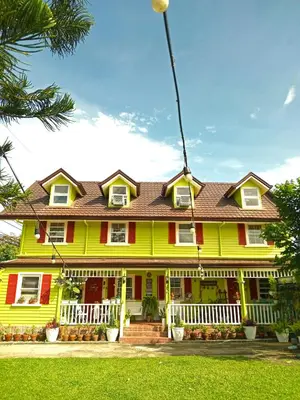 a yellow house with a red and white house at Madie's Place Guest House in Santa Rosa