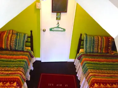 a room with two beds and a white door at Madie's Place Guest House in Santa Rosa