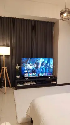 a large flat screen tv sitting in a living room at 101 Newport blvd C2 4F by Rechelle Nunag in Manila