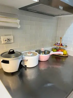 a kitchen counter with several pots and pans on it at Overnight @ Shakhbot's in Manila