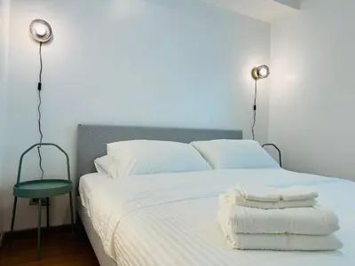 a bedroom with a bed with towels on it at Avant at the Fort by Urban Realty in Manila