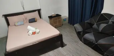 a bedroom with a bed with two stuffed animals on it at ADB Avenue Tower Ortigas Manila in Manila