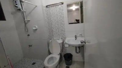 a bathroom with a toilet and a sink and a shower at ADB Avenue Tower Ortigas Manila in Manila