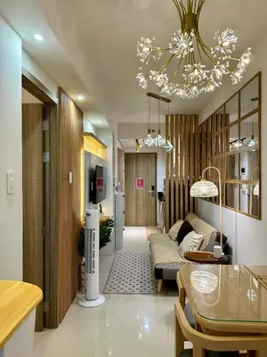 a living room with a couch and a chandelier at S Residences Tower 3 MOA Luxe Staycation by C in Manila