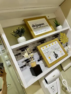 a woman taking a picture of a beauty counter in a store at S Residences Tower 3 MOA Luxe Staycation by C in Manila