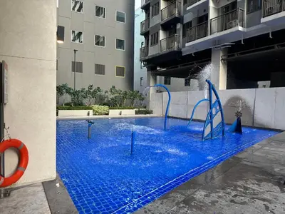 a pool with a water slide in a building at S Residences Tower 3 MOA Luxe Staycation by C in Manila