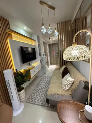 a living room with a couch and a tv at S Residences Tower 3 MOA Luxe Staycation by C in Manila
