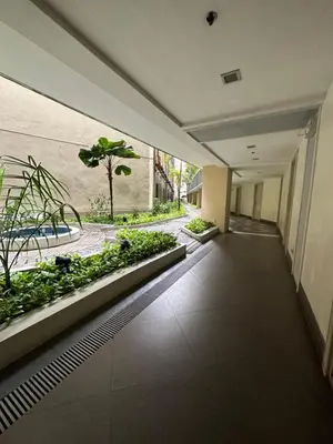 an empty hallway with plants in a building at Cecillian place staycation @ pasay in Manila