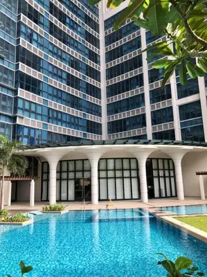 a large building with a large swimming pool in front of it at Uptown Parksuites BGC 1BR, Hi Flr Great view fr Balcony with Washer in Manila