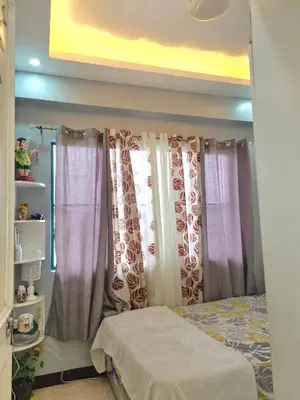 a bedroom with purple and white curtains and a bed at Budget-friendly Transient Near Pasig/Mandaluyong in Cainta