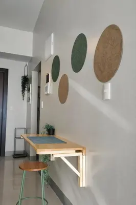 a table and two stools in a room at 20F Modern Cozy BGC Suite across 2 Major Malls with Washer FREE Parking in Manila