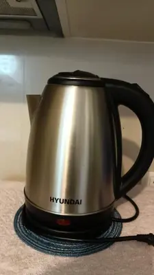 a silver and black tea kettle sitting on a counter at Hilanders Condotel in front of Terminal 3 in Manila