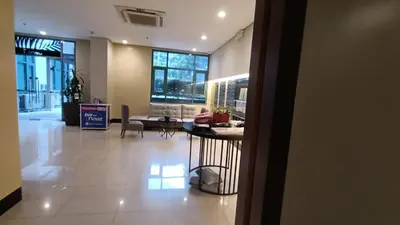 a lobby with a couch and a table in a building at Hilanders Condotel in front of Terminal 3 in Manila