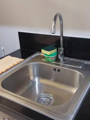 a kitchen sink with a sponge and a faucet at MOA staycation by Elsie D in Manila