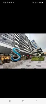 a sign on the side of a tall building at MOA staycation by Elsie D in Manila
