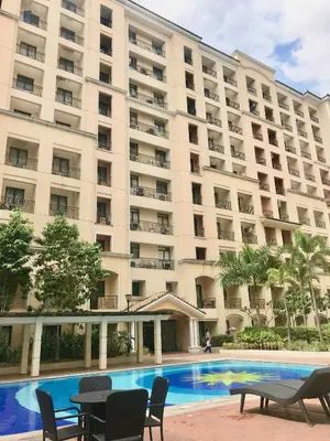 a large building with a pool in front of it at Manila Airport Staycation near NAIA Terminal 3 in Manila