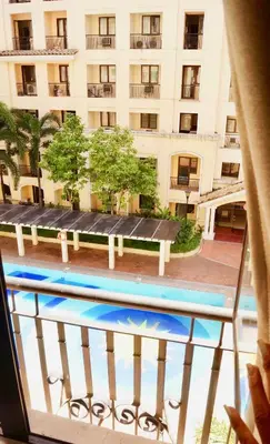 a view from a balcony of a building with a pool at Manila Airport Staycation near NAIA Terminal 3 in Manila