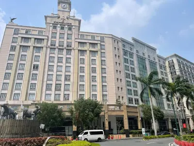 a large building with a clock tower on top of it at 150 Newport Blvd - Near T3 Airport in Manila