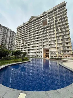 a large apartment building with a large swimming pool at Condo for Families and Friends in Manila