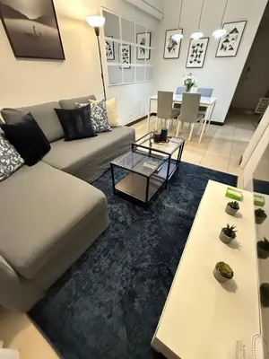 a living room with a couch and a table at Condo for Families and Friends in Manila