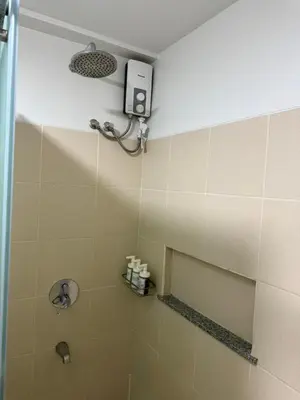 a bathroom with a shower with a shower head at Condo for Families and Friends in Manila
