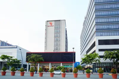 a building with potted plants in front of a building at Red Planet Manila Aseana City in Manila